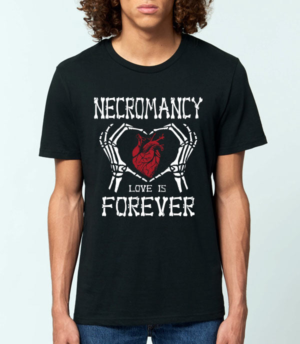 A man wearing a black short-sleeve graphic t-shirt with a white skeleton heart design and the words 'NECROMANCY LOVE IS FOREVER' in distressed white lettering.