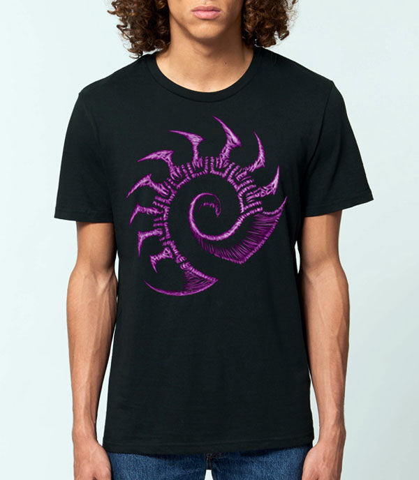 A man wearing a black crewneck t-shirt with a large purple stylized zerg logo graphic on the front, set against a light gray background.